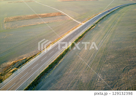 Aerial view of empty intercity road at sunset. Top view from drone of highway in evening Aerial view of empty intercity road at sunset. Top view from drone of highway in evening 129132398