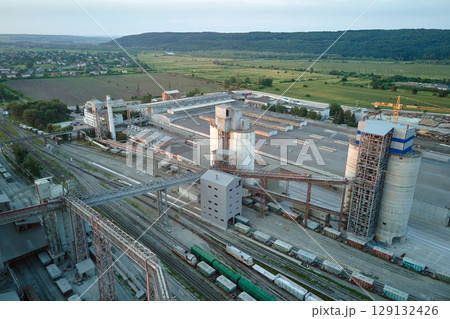 Aerial view of cargo train cars loaded with construction goods at mining factory. Railway transportation of industrial production raw materials Aerial view of cargo train cars loaded with construction goods at mining factory. Railway transportation of industrial production raw materials 129132426