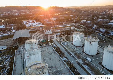 Aerial view of big fuel reservoires in petrol industrial zone in winter. 129132443