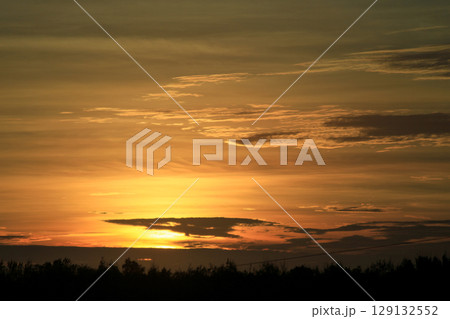 Golden sunset sky over Longgang Harbor in Miaoli, Taiwan. 129132552