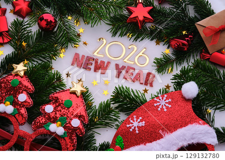 Abstract background of Christmas attributes The inscription NEW YEAR 2026. Abstract background of Christmas attributes The inscription NEW YEAR 2026. 129132780