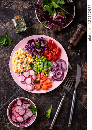Balanced healthy bowl with vegetables and salmon 129132986