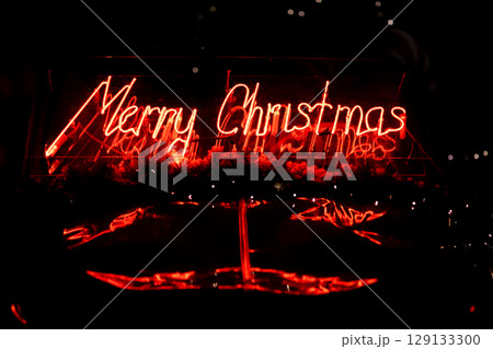 led red Christmas decoration and ornaments over abstract bokeh background with copy space. Holiday background greeting card for Christmas and New Year. Merry Christmas led red Christmas decoration and ornaments over abstract bokeh background with copy space. Holiday background greeting card for Christmas and New Year. Merry Christmas 129133300