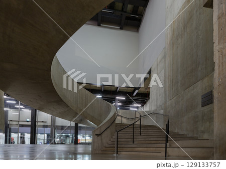 A curving flight concrete spiral staircase at Blavatnik Building of Tate Modern Switch House extension. 129133757