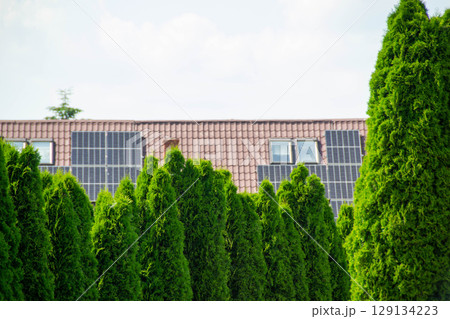 House roof with photovoltaic modules. Historic farm house with modern solar panels on roof and wall High quality photo House roof with photovoltaic modules. Historic farm house with modern solar panels on roof and wall High quality photo 129134223