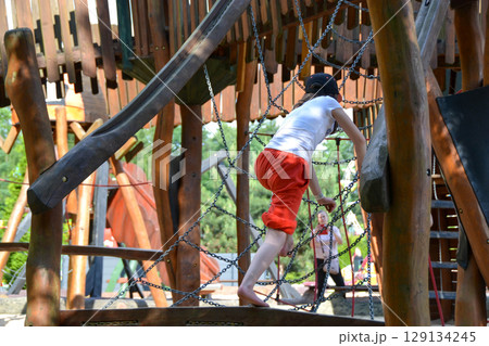 life of children in a modern city - little boy is having fun on the playground near the house. High quality photo 129134245