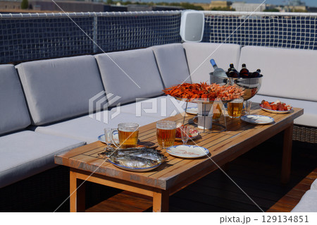 An Elegant Rooftop Gathering Featuring Delicious Food and Refreshing Drinks for Everyone 129134851