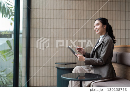 Confident Businesswoman Using Tablet in Modern Office Environment for Professional Success and Innovation Confident Businesswoman Using Tablet in Modern Office Environment for Professional Success and Innovation 129138758