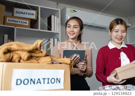 Volunteers Organizing Donations in a Community Center for Charity and Support Initiatives Volunteers Organizing Donations in a Community Center for Charity and Support Initiatives 129138922