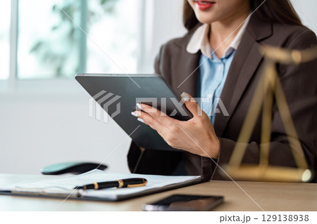 Female Lawyer Using Tablet in Modern Office 129138938