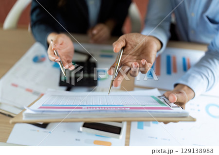 Data Analysis. Professionals reviewing financial reports and discussing strategies. 129138988