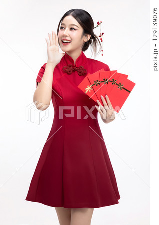 Portrait of joyful beauty Asian woman in red Cheongsam Chinese traditional dress celebrating with lucky red envelopes on Chinese New Year festival isolated on white background. Portrait of joyful beauty Asian woman in red Cheongsam Chinese traditional dress celebrating with lucky red envelopes on Chinese New Year festival isolated on white background. 129139076