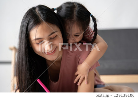Young Child Engaged in Learning Activities at Home with Parent in a Cozy and Modern Living Space 129139106