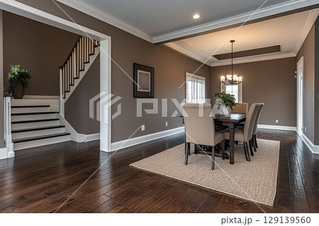 A large, elegant dining room with a long wooden table and chairs 129139560