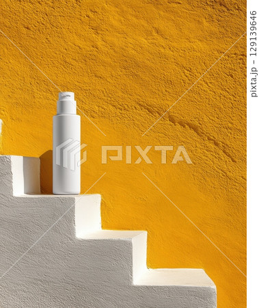 A bottle of lotion is sitting on a set of white steps 129139646