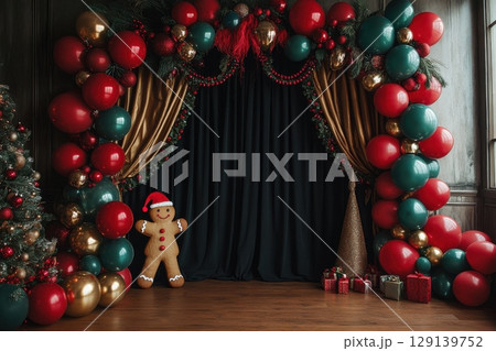 A Christmas scene with a gingerbread man standing in front of a curtain 129139752