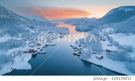 A snowy landscape with a river and houses 129139852