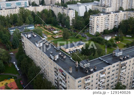 This aerial view showcases an urban area rich in green spaces, balancing nature and city living This aerial view showcases an urban area rich in green spaces, balancing nature and city living 129140026