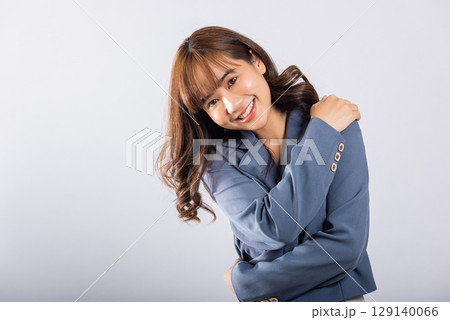 Happy beautiful young smiling Asian businesswoman hugging herself remember moment studio short isolated on white background, Self care and self esteem concept, Lifestyle female love yourself carefree 129140066