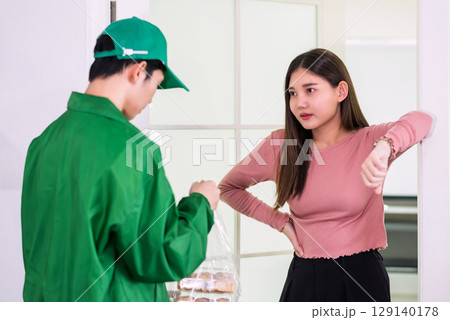Asian woman piss off about food delivery delay while delivery man regret 129140178
