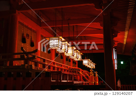 Illuminated lantern hang by red ceiling of Fushimi Inari at night, Kyoto Illuminated lantern hang by red ceiling of Fushimi Inari at night, Kyoto 129140207