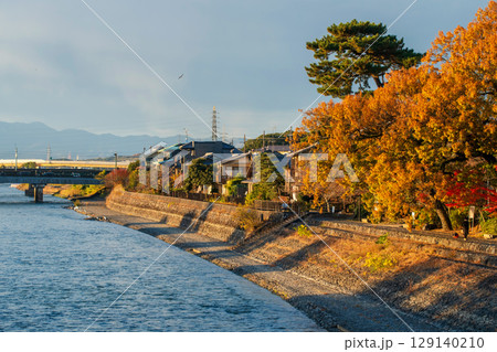Uji riverside village by Uji-gawa river in autumn at sunset, Kyoto Uji riverside village by Uji-gawa river in autumn at sunset, Kyoto 129140210