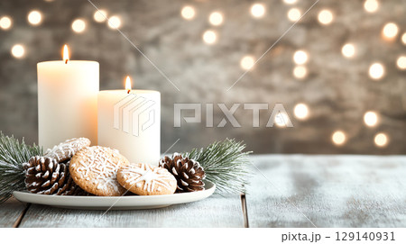 Cozy holiday scene with candles, cookies, and pine cones on table. warm glow creates festive atmosphere, perfect for celebrations 129140931