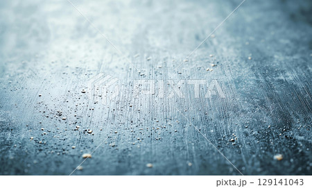 Abstract background textured metallic surface with scattered particles and brushed finish creates unique and modern backdrop. This abstract design evokes sense of depth and intrigue 129141043