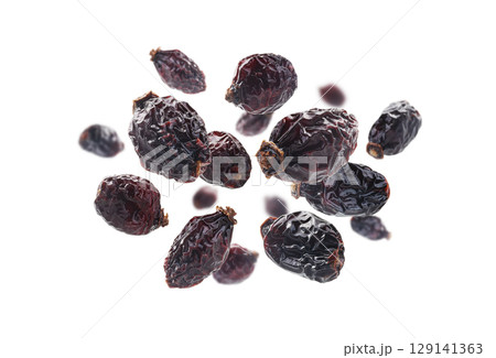 Dried rosehip berries levitate on a white background Dried rosehip berries levitate on a white background 129141363