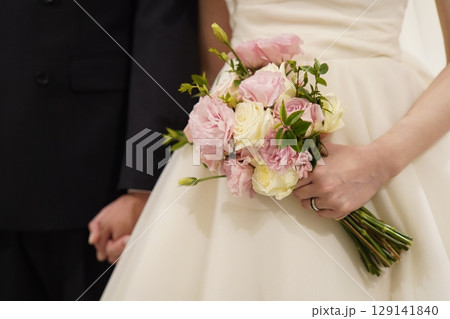 wedding bouquet in hands of the bride wedding bouquet in hands of the bride 129141840