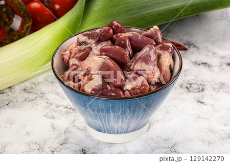 Raw chicken hearts in the bowl 129142270