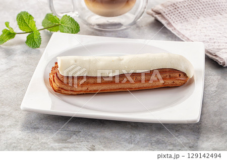 White vanilla eclair with icing White vanilla eclair with icing 129142494