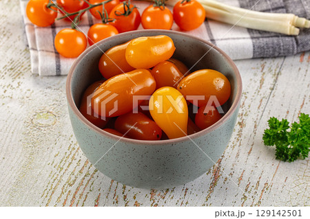 Marinated yellow cherry tomatoes heap Marinated yellow cherry tomatoes heap 129142501