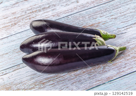 Raw ripe violet eggplant heap 129142519