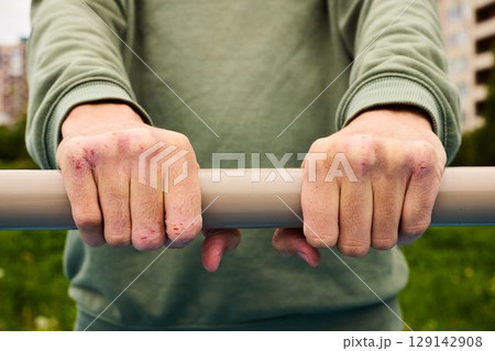A Firm Grip on a Fitness Bar in a Vibrant Urban Scene, Engaging in Active Training A Firm Grip on a Fitness Bar in a Vibrant Urban Scene, Engaging in Active Training 129142908