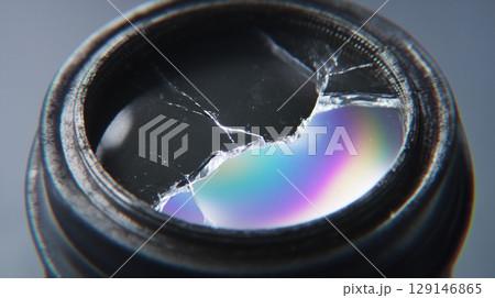 AI Quantum Development concept, Broken camera lens with colorful reflection and cracks visible. 129146865