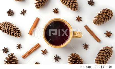 Warm drink with spices and pinecones arranged on a white surface for cozy winter vibes 129148046