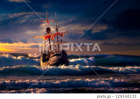 Grand view of an old sailing ship from the times of pirates on the high seas with big waves 129148133