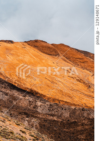 A volcanic landscape with desert and rocky mountains. A volcanic landscape with desert and rocky mountains. 129148671