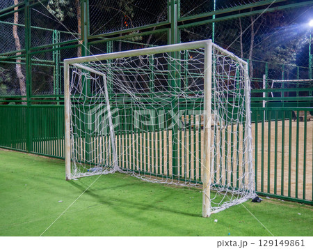 football field in the evening. Artificial lawn. Available infrastructure. Empty sports ground. Football game concept. Empty. Football goal net. Under the lanterns football field in the evening. Artificial lawn. Available infrastructure. Empty sports ground. Football game concept. Empty. Football goal net. Under the lanterns 129149861