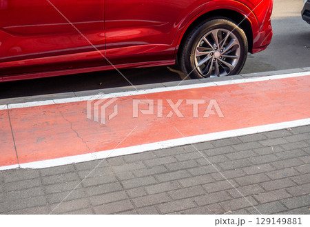 Bike path in the city. Part of the bike path. Convenience for cyclists in a modern city. Potholes.  Red highlighted area. 129149881