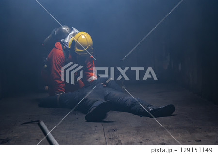 Firefighter help people in the burning warehouse / Fire and rescue training school regularly to get ready. Firefighter help people in the burning warehouse / Fire and rescue training school regularly to get ready. 129151149