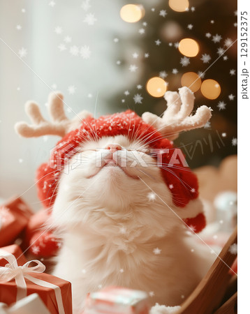 Adorable fluffy cat with antlers in a festive holiday scene, surrounded by christmas gifts and snowflakes. 129152375