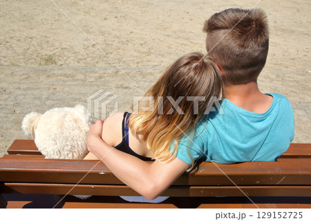 A couple is happily enjoying a lovely day outdoors together with their adorable dog A couple is happily enjoying a lovely day outdoors together with their adorable dog 129152725