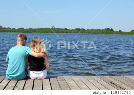 A Couple Enjoying a Peaceful and Relaxing Moment Together by the Waters Edge on a Beautiful Day A Couple Enjoying a Peaceful and Relaxing Moment Together by the Waters Edge on a Beautiful Day 129152739
