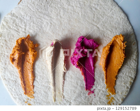 Indulge in Colorful Dips on Flatbread for an Irresistibly Appetizing Snack Experience Indulge in Colorful Dips on Flatbread for an Irresistibly Appetizing Snack Experience 129152789