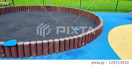 A vibrant and colorful playground featuring a spacious sandpit along with durable rubber flooring 129153010