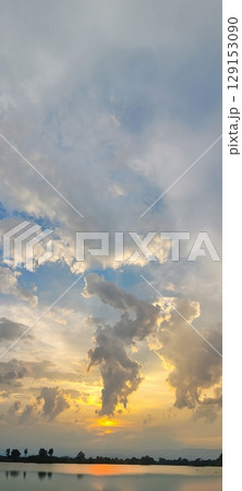 A Breathtaking Sunset Paints the Sky Over Serene Waters, Framed by Dramatic Skies Above A Breathtaking Sunset Paints the Sky Over Serene Waters, Framed by Dramatic Skies Above 129153090