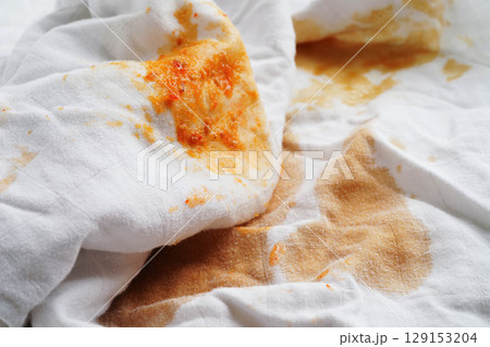 Dirty tomato sauce stain removal or ketchup on cloth accident to wash with washing powder, cleaning housework. Dirty tomato sauce stain removal or ketchup on cloth accident to wash with washing powder, cleaning housework. 129153204