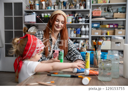 Creative Moments A Mother and Her Child Crafting Together in Joyful Harmony and Fun 129153755